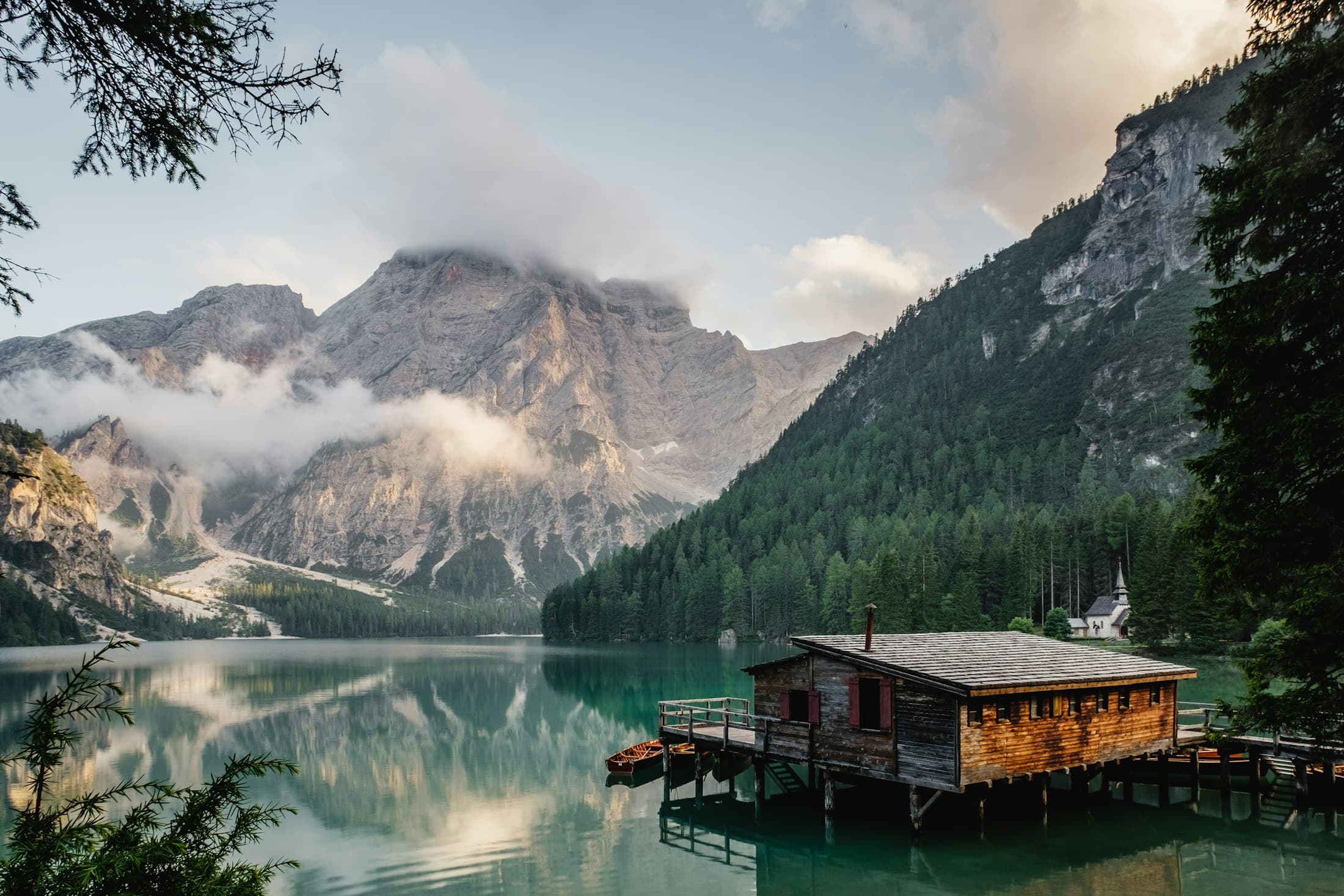 Site study: the boathouse that has stood on the lake for a century — proof of how little the shore needs.