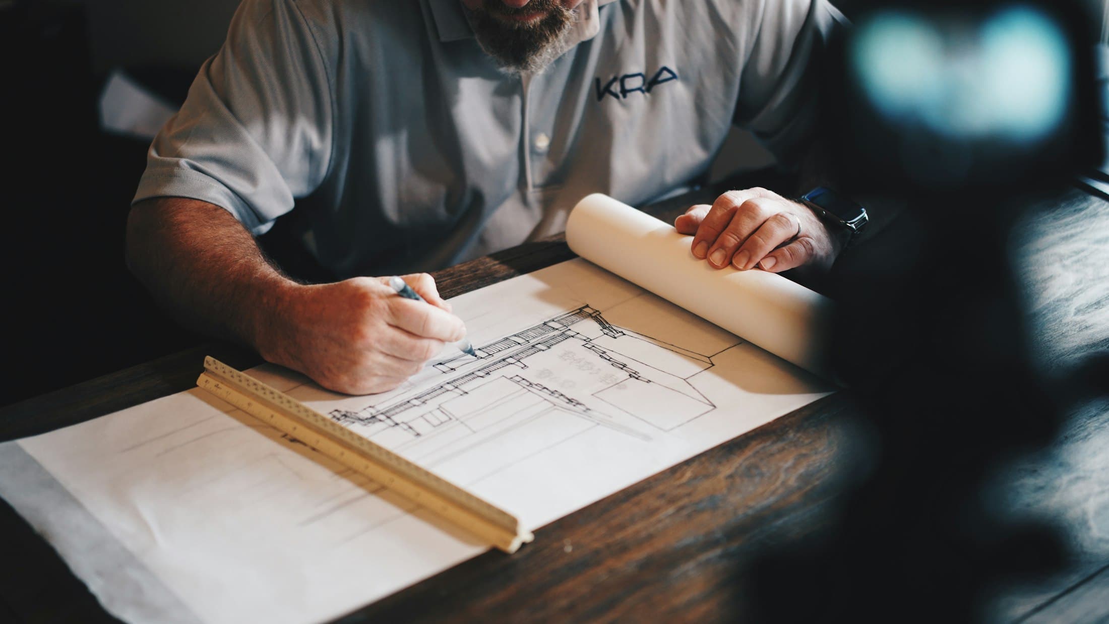 Hand-drafting a plan with pencil and ruler