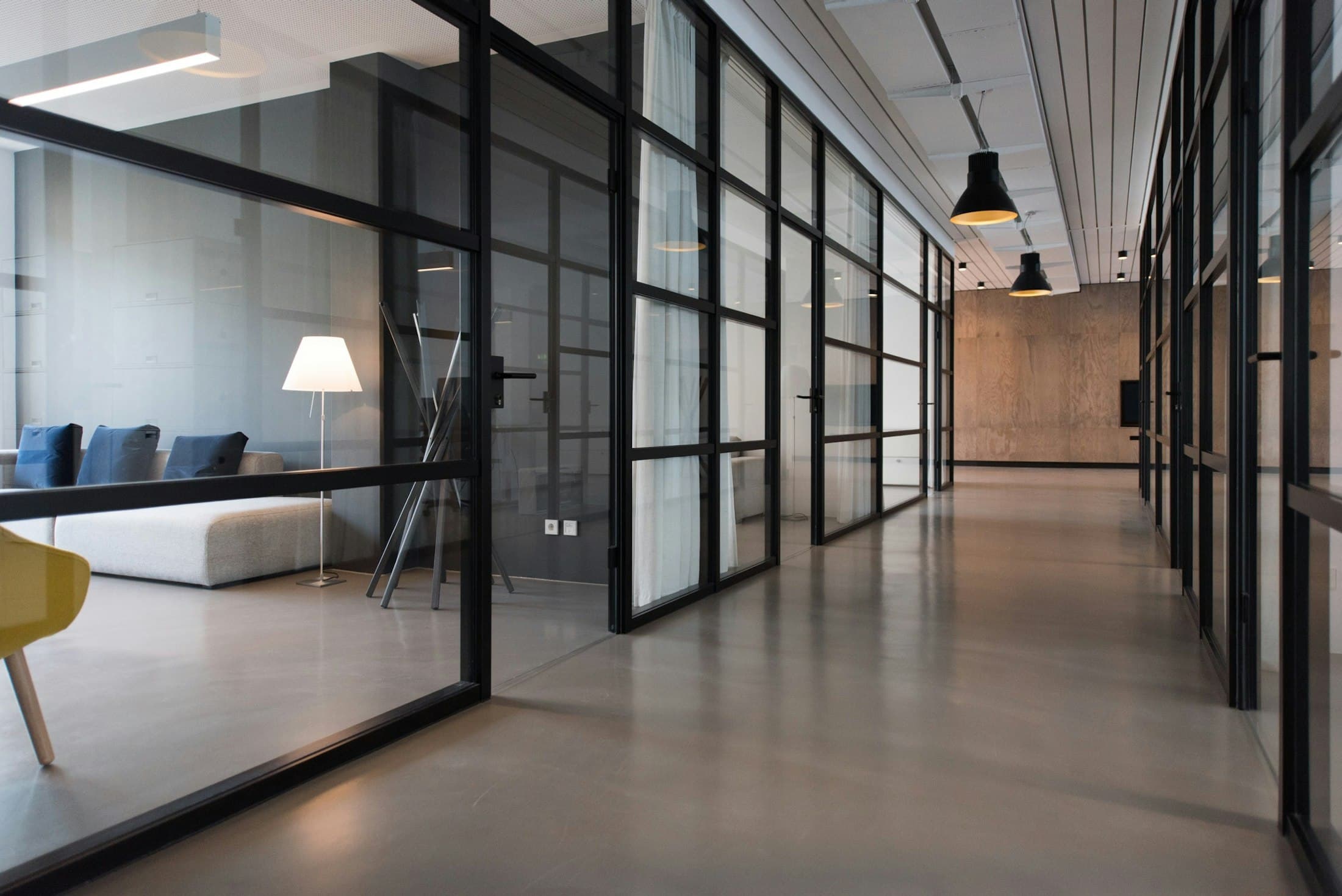 Archive galleries behind steel-framed glazing — the collection visible from the public corridor, guarded but not hidden.