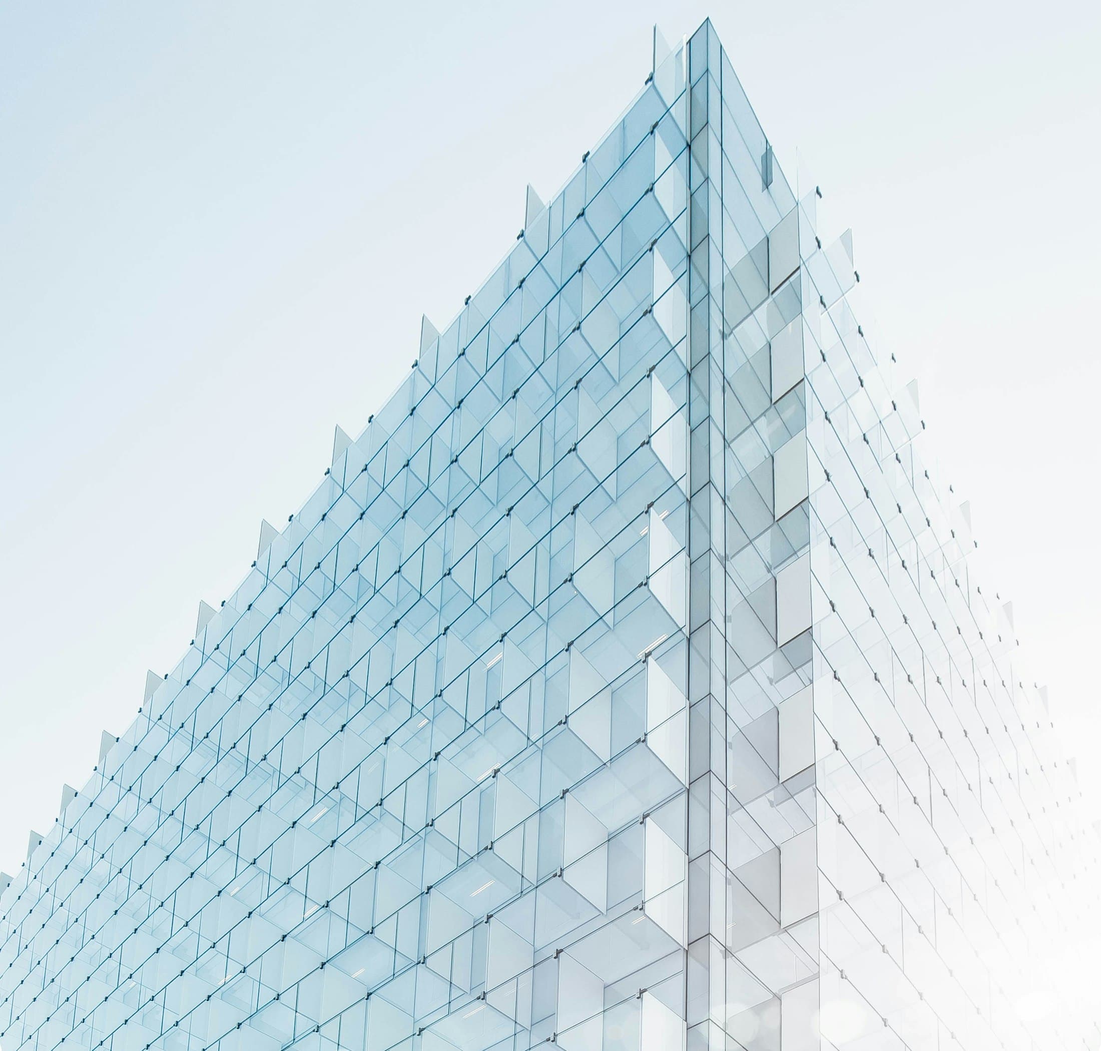The atrium's faceted glazing. After dark, rehearsals light the corner of the block.